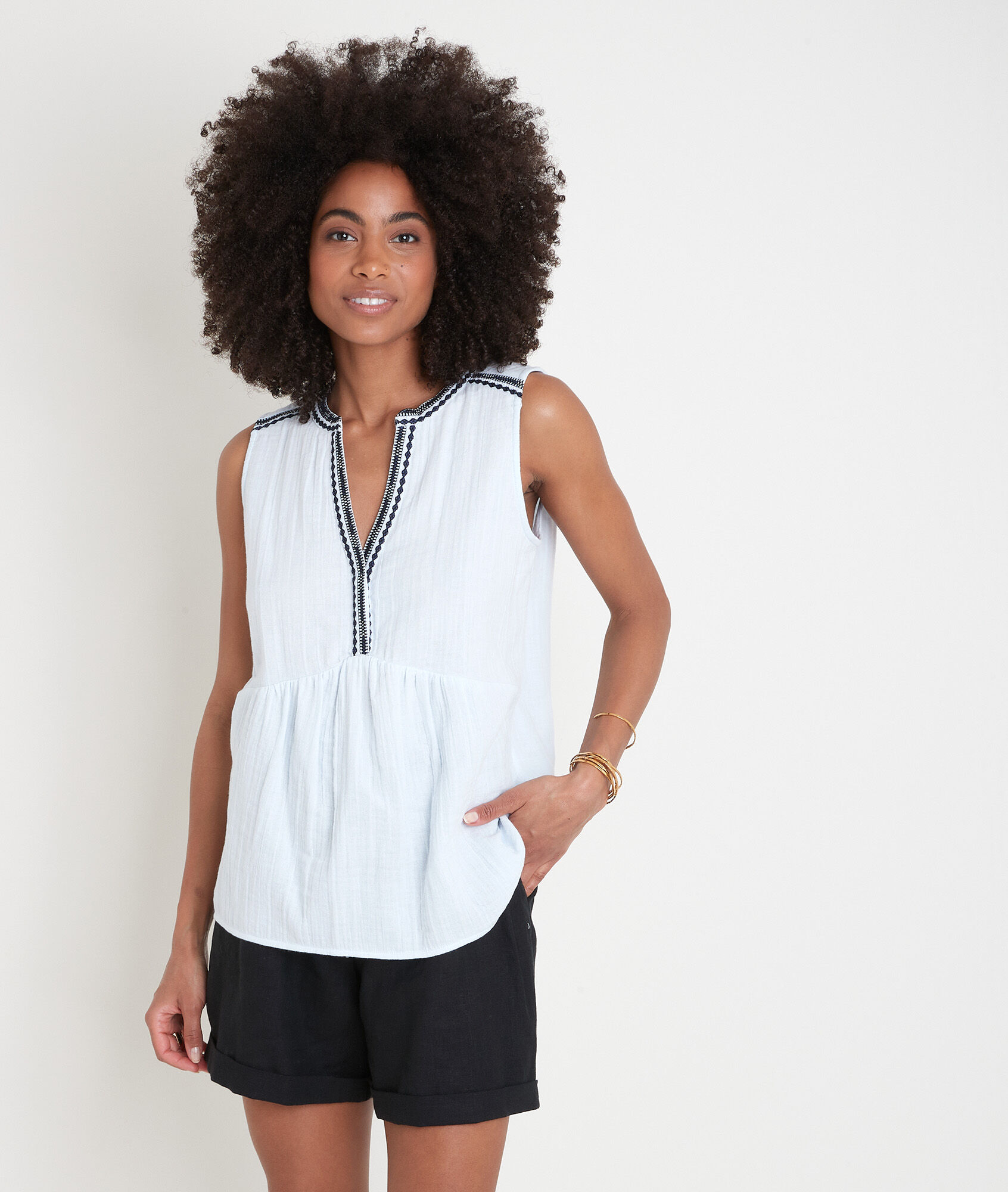 pale blue sleeveless blouse