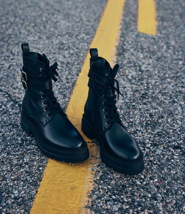 Neon black leather combat-style boots