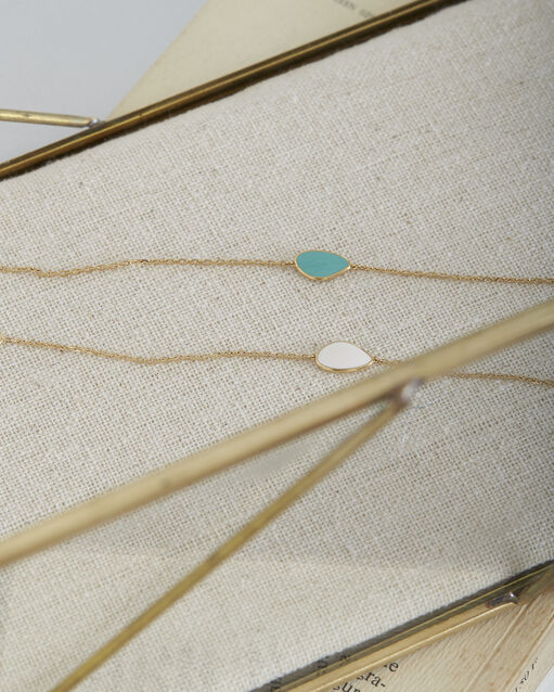 Tarsana gold bracelet with white teardrop white.