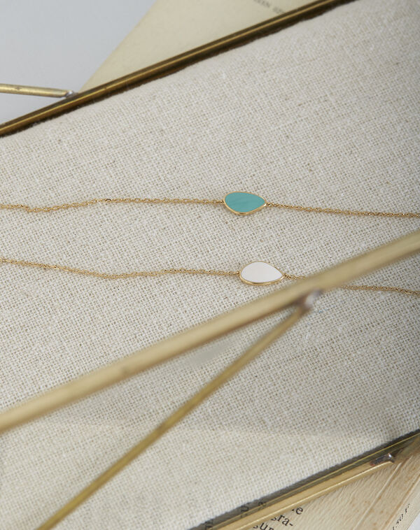 Tarsana gold bracelet with green teardrop apple.